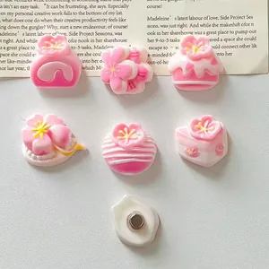 Close-up of pink cherry blossom and cake resin fridge magnets showing the back magnet