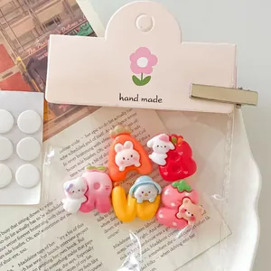 Macro detail of cute rabbit and bear fruit resin charms for DIY jewelry and hair accessories