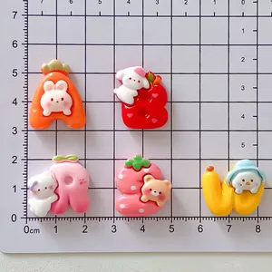 Macro view of cute cartoon resin letter charms for DIY projects with measurements
