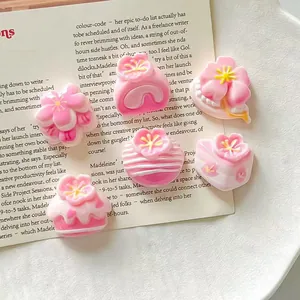 Close-up detail of 3D pink sakura flower resin charms for DIY handmade crafts and decor