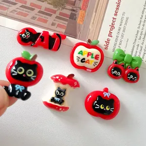 Detailed macro view of various cute cartoon cat and apple resin charms for DIY craft projects