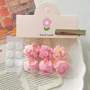 Close-up of pink cherry blossom resin cake charms for DIY hair accessories