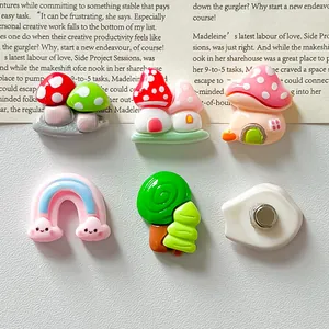 Close-up of cute mushroom house and rainbow resin fridge magnets with back magnet