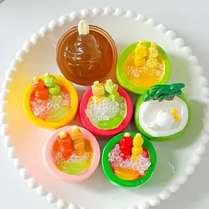 Macro detail showing assorted colorful miniature resin dessert bowls on a white plate.
