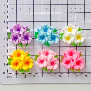 Close-up view of colorful glossy resin flower patches displayed on a centimeter scale grid mat
