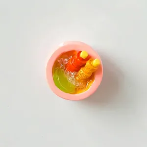 Detailed macro shot of a miniature resin dessert bowl fridge magnet with lemon slice
