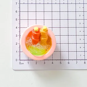 Close-up detail of a miniature resin food bowl magnet with lemon slice and bottles