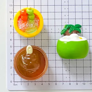 Detail of resin food miniatures showing size on a 1cm grid measurement mat