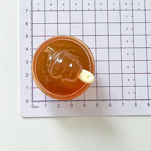 Miniature handmade mango sago resin fridge magnet accessory on a scale measurement mat