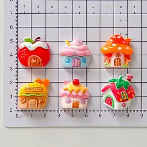 Detail view of colorful cartoon resin charms showing size comparison on a centimeter mat.