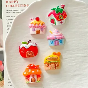 Close-up of colorful cartoon resin houses including mushroom, fruit, and burger designs.