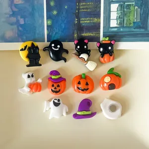 Detail view of colorful Halloween resin charms with pumpkin, ghost and cat shapes