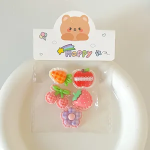 Detailed view of cute DIY resin fruit charms with lace plaid patterns in packaging