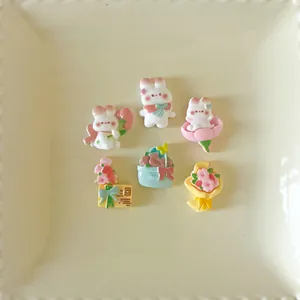 Detailed view of cute resin rabbit and flower charms for DIY crafts and phone case decor