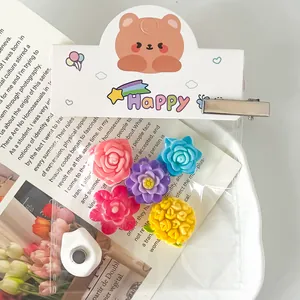 Macro view of colorful resin cherry blossom and peach blossom flower charms for DIY crafts