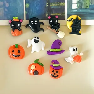 Various cute Halloween resin charms including ghosts, pumpkins, and black cats.