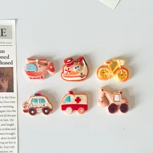 Detailed view of six cartoon transportation resin charms for DIY crafts and accessories