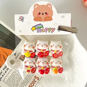 Close-up of 6pcs white lucky cat charms for DIY jewelry and custom shoe decoration