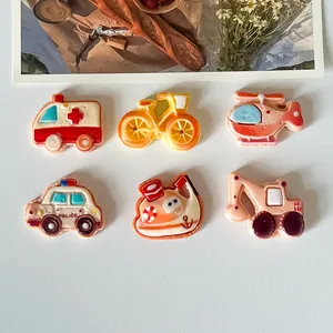 Detailed view of colorful cartoon resin charms for DIY fridge magnets and shoe accessories.