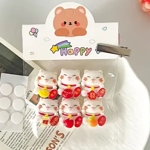 Detail of cute Maneki Neko charms for DIY shoe accessories and phone case decor