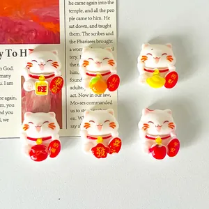 Detailed macro shot of six cute Maneki-neko lucky cat resin charms for DIY craft use