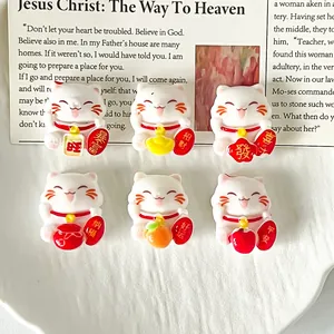 Detailed view of six miniature white lucky cat charms for DIY crafts and accessories