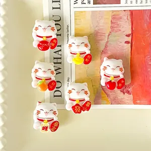 Detailed view of DIY lucky cat resin charms with traditional fortune characters
