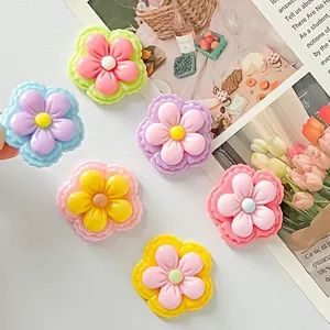 Detailed macro view of colorful glossy resin five-petal flower DIY craft accessories