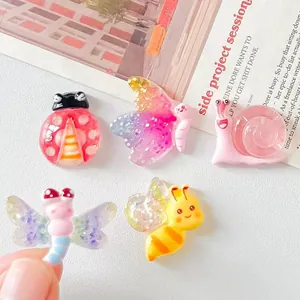 Detailed macro view of colorful resin insect charms including butterfly and bee for DIY