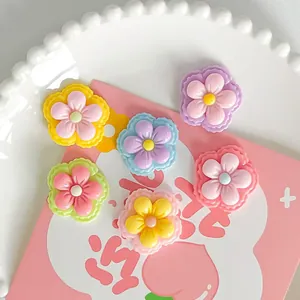 Macro view of colorful glossy resin 5-petal flower charms for DIY hair clip accessories