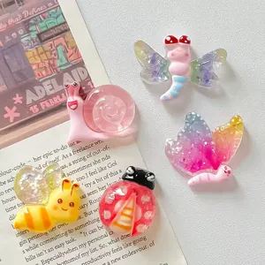 Macro view of colorful resin insect charms like butterfly and snail for DIY crafts