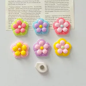 Detailed view of colorful glossy resin five-petal flower refrigerator magnets.