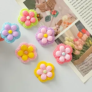Detailed macro view of colorful glossy resin five-petal flower DIY craft accessories