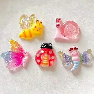 Detailed view of colorful cartoon resin insect charms for DIY crafts and accessories