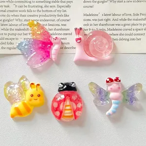 Detailed view of colorful cartoon resin insect charms including butterfly and bee