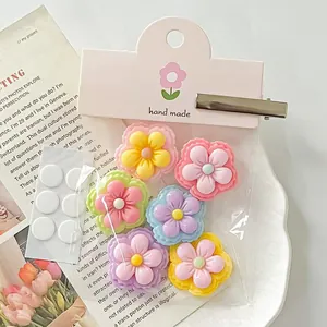 Close-up of glossy double-colored resin flowers for DIY hair clips and crafts