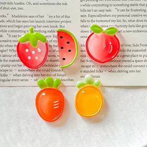 Detalle de dijes de resina translúcida de frutas como fresa, sandía y durazno