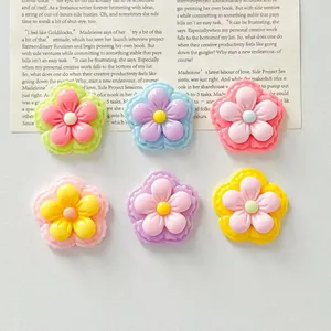Close-up of colorful glossy five-petal resin flower charms for DIY hair accessories