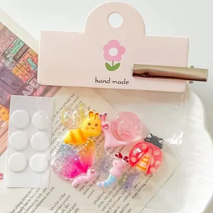 Detailed macro view of DIY cartoon insect resin accessories with handmade packaging card