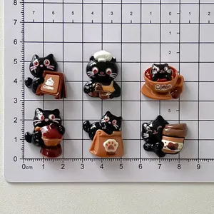 Detailed view of six cute black cat resin charms on a centimeter grid for DIY crafts