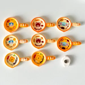 Detail view of cartoon frying pan fridge magnets featuring cat bear and koala designs
