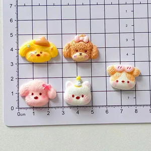 Detailed view of cute cartoon puppy resin charms shown against a centimeter scale