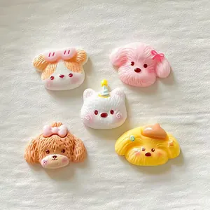 Set of five colorful cute resin dog head hair accessories on white background.