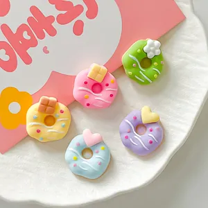 Detailed view of colorful pastel donut-shaped resin charms for DIY jewelry and hair accessories