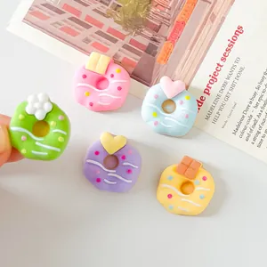 Macro view of colorful sweet donut resin charms for DIY craft projects and hair accessories