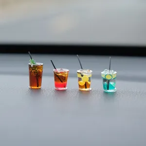 Detailed view of four miniature colorful beverage cups as car dashboard ornaments