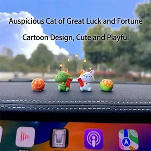 Detailed macro view of cute lucky cat and orange figurines placed on a car dashboard