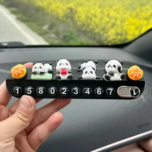 Detailed view of creative panda car parking phone number plate with cute figurines