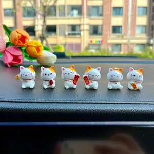 Set of six cute mini Maneki-neko lucky cat figurines on car dashboard decoration