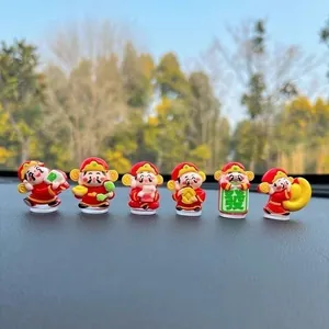 Detailed view of six cute cartoon God of Wealth figurines on a car dashboard for luck